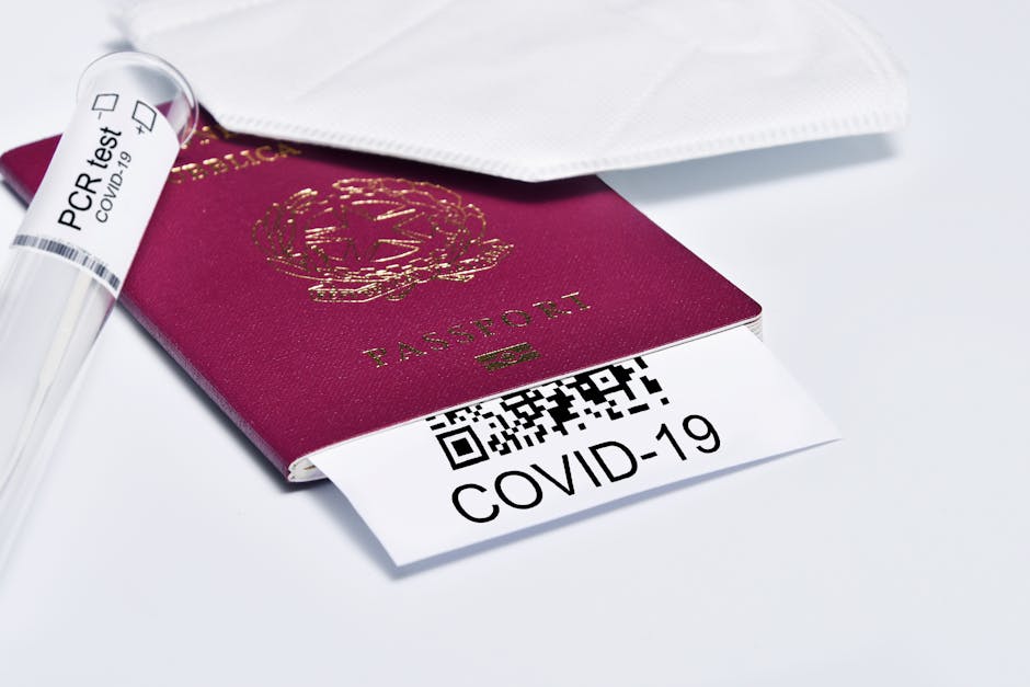 pexels-photo-11624061-11624061 Close-up of a passport with COVID-19 test tube and face mask representing travel protocols.